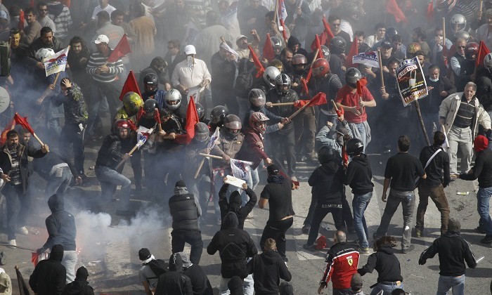 Communists clash with black-clad youths near the Parliament building in Syntagma square in Athens